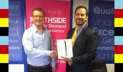 Richard Campbell of Northside Graphics accepting his iPad2 from Conor Power of Neopost Ireland...